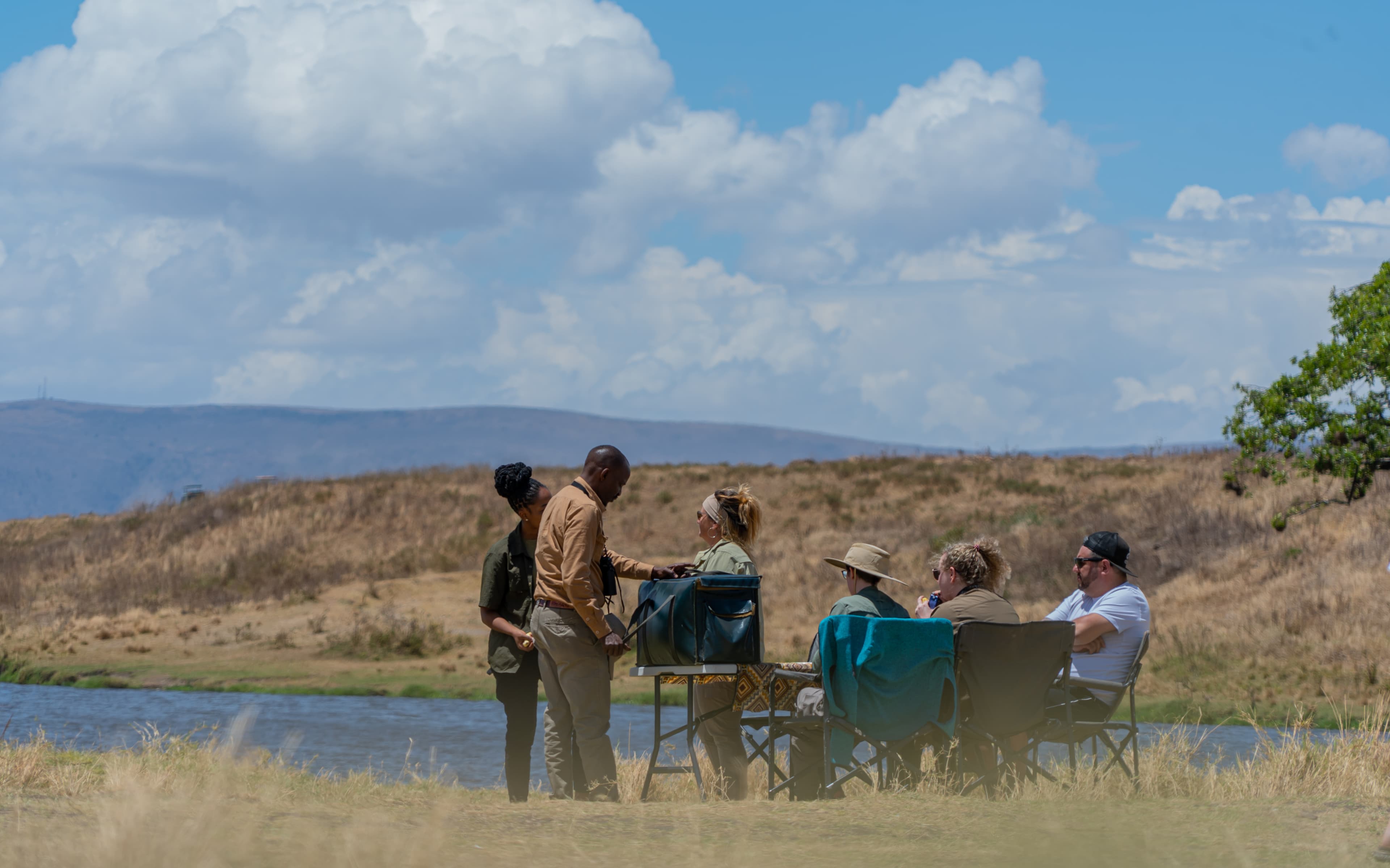 Safari travellers pausing beside the water in Tanzania